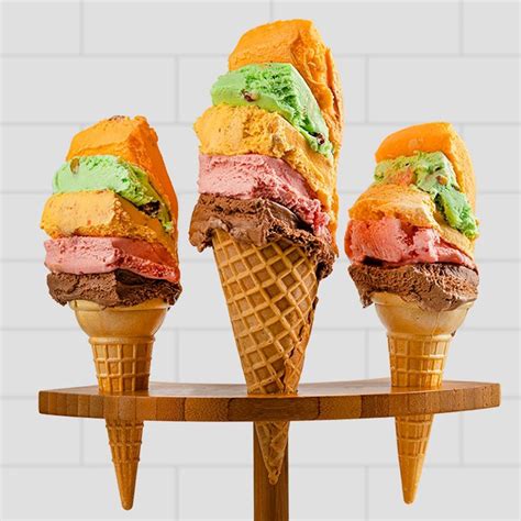 Original rainbow cone. The Original Rainbow Cone, originating from Chicago in 1926, is a beloved ice cream institution known for its unique five-flavor cones stacked with Orange Sherbet, Pistachio, Palmer House, Strawberry, and Chocolate. They offer a variety of treats including mini donuts, tiered cakes, and cake rolls featuring their signature flavors. ... 