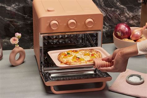 Our place wonder oven. Heat range: 200° – 450°F. Timer: 0 – 60 minutes. Includes a wire rack, bake pan, air fryer basket and crumb tray. Multilevel design, so you can cook multiple meals at once. 1-year warranty. 