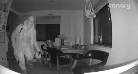Out-of-town couple watches armed burglar in home on surveillance camera