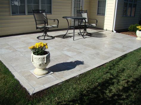 Outdoor patio tiles over concrete. Summer is just around the corner, which means it’s time to start thinking about your outdoor entertaining space. Whether you’re planning on hosting a backyard BBQ or simply want a ... 