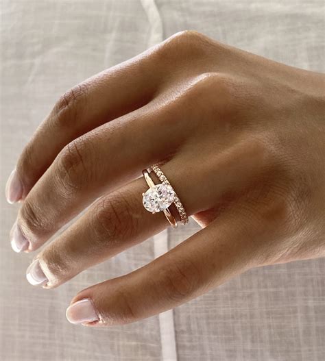 Oval engagement ring and wedding band set. On your wedding day, a coordinating round-cut stone-lined bands complete this gleaming look. This bridal set celebrates every chapter as your unique journey of ... 