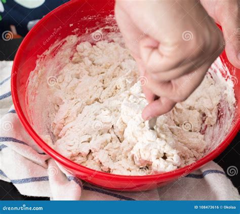 Overhead view of hands put dough in a oil bowl and covered the bowl …