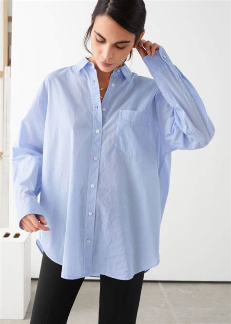Oversized blue shirt women. WOMEN'S SHIRTS. Our women's shirts come in a variety of materials, colours and styles to suit every event. Dress up with a crisp white shirt tucked into a midi skirt and heels. For a more pared back look, throw on a checked shirt tied around your waist to add a grungy edge to your outfit. A denim shirt will never go out of style. 