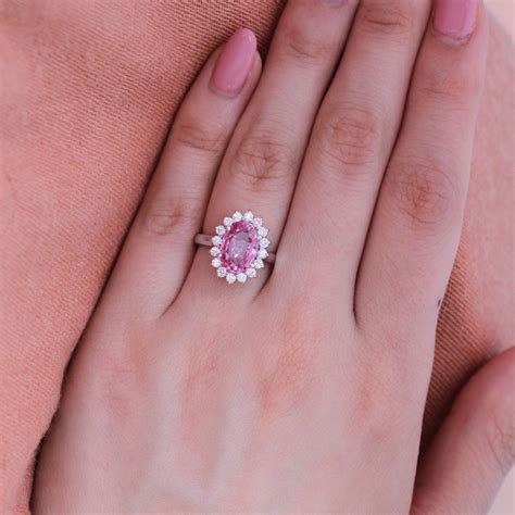 Padparadscha sapphire ring. Learn about the rare and valuable padparadscha sapphire, a blend of orange and pink colors. Find out how to identify, buy, and care for this gemstone in jewelry. 