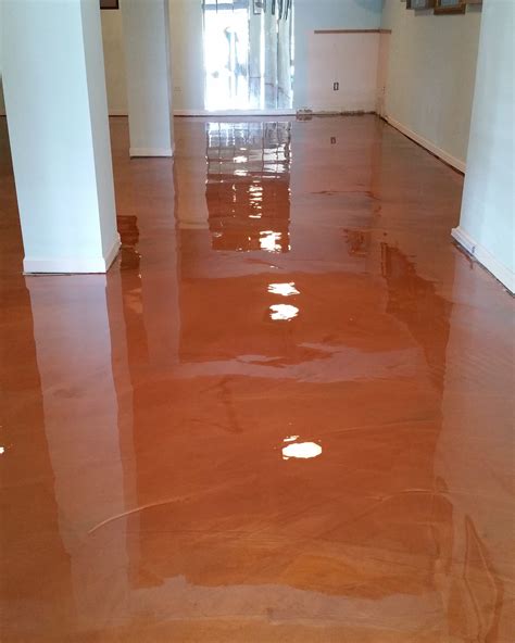 Painted concrete floor. Apply a thick layer of the paint stripper using a brush, broom, squeegee, or another approved tool. Check the instructions for more options. Let the paint stripper sit until it fully penetrates the concrete, which causes the paint to soften. This takes four to 24 hours. Remove the paint with a scraper or wire brush. 