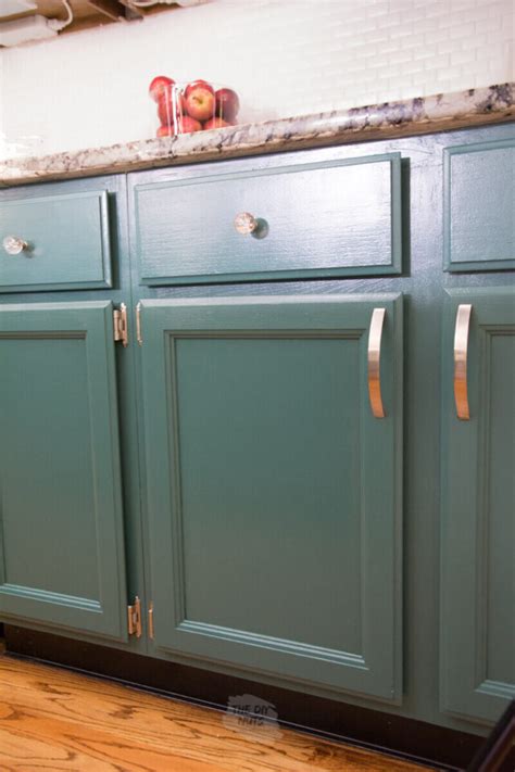 Painting cabinet doors. Start at the top, left cabinet. That’s one. The one to the right is two, and so on. Number all of your upper cabinets and then start numbering the lower drawers and cabinets. In our example, the first drawer is 12, the cabinet doors below that are 13 and 14, and so on. Once your map is drawn, it’s time to remove the pieces. 