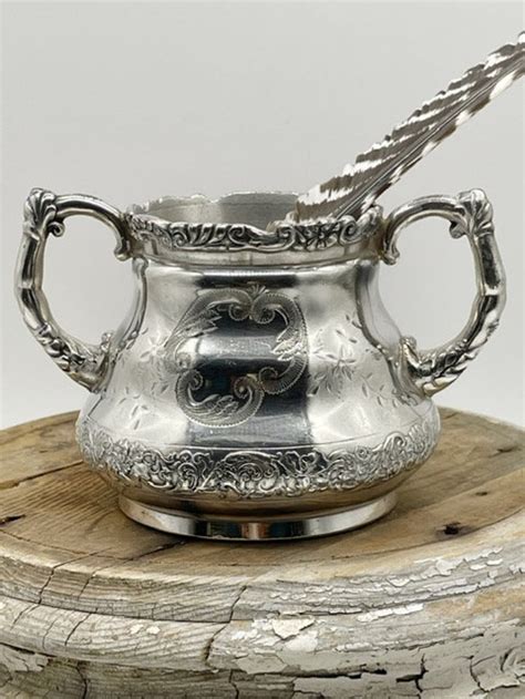 Antique Pewter Pairpoint Mfg Coffee Pot, Quadruple plate, Markings 309/6, Manufactured between 1850 - 1899, Engravings include birds, plants, and spiders. This little treasure is 9 tall and approximately 9 wide from tip of handle to tip of spout.. 