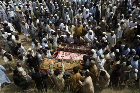 Pakistan buries the dead after 54 killed in a bombing at an election rally for a pro-Taliban cleric