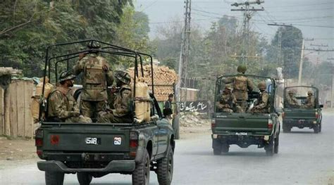 Pakistani security forces kill 2 insurgents in shootout after attack on a convoy