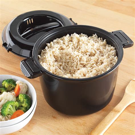 Pampered chef rice cooker. To cook rice in a microwave, you simply add one cup (240ml) of water to a large ceramic bowl and cover it with a microwavable plate or dish. Then, poke several holes into the lid to allow steam to escape during cooking. After adding 1 cup (240ml) of white rice, place the covered bowl in the microwave and set it to cook for 15 minutes. 