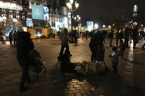 Paris City Hall plaza draws holiday visitors and migrant families seeking shelter as Olympics nears