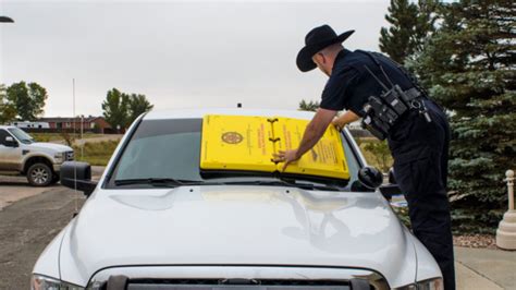 The Barnacle is a 20 pound piece of yellow plastic that can be easily suctioned onto a parking violator’s windshield — enforcement officers just pump the device and arm it with a keypad. Once violators call the number provided and make their payment, they receive the code to unlock the Barnacle and can easily take it off their car.. 