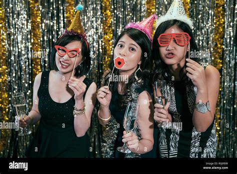 Party teens showing.  Less Searching, More Finding With Getty Images.  Young Asian female frien...