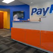 The PayPal logo displayed on a smartphone screen with a stock market graphic in the background. Covid accelerated the move away from cash payments — both in stores and via the push to online .... 