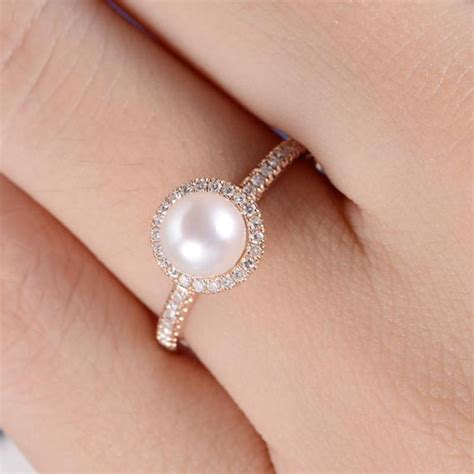 Pearl engagement ring. The ring features solid 18k gold and 0.37 carat diamonds. An engagement ring with a pearl as the center focus is a unique and romantic choice. Stone's exact ring is actually available now for ... 