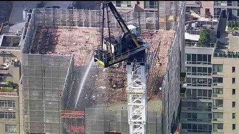 Pedestrians scatter as fire causes New York construction crane’s arm to collapse and crash to street