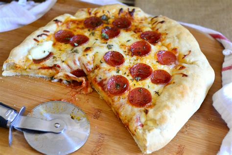 Pepperoni stuffed crust pizza. Poke holes all over the top crust, to allow steam to escape. Repeat with the remaining dough and ingredients, making another 9" round pizza. Allow the pizzas to rest/rise, covered, for about 30 minutes. Meanwhile place one oven rack at the bottom of the oven and one rack towards the top. Preheat the oven to 425°F. 