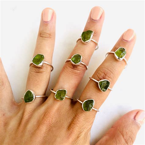 Peridot rings. Diamond X Crossover Band. Size: 6. Est. Retail $395.00. $205.00. Now 20% off - $164.00. 18K white gold Bvlgari cocktail ring with rectangular cushion cut peridot at center featuring engraved logo accents at sides. 