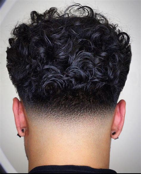 A trendy low taper is a masculine yet soft and swept-back hairstyle. It blends a fade around the temples with an easy brushback hairstyle. To get this look, tell your barber you want a temple fade. Make sure there’s enough hair left on top to sweep back usually, 3-5 inches is ideal, but it will depend on your hair texture.. 