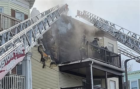 Person hospitalized, dozens displaced after fire tears through 2 buildings in Dorchester
