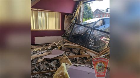 Person taken to hospital after car crashes into building in Watertown