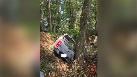 Person taken to hospital after pickup truck crashes into wooded area in Hanover