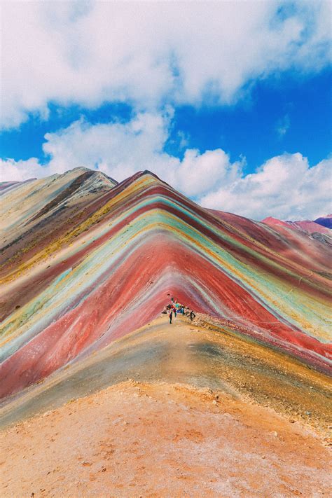 Peru rainbow mountain. Rainbow Mountain sits in the shadow of the Cordillera Vilcanota, and Nevado Auzangate, some 90 miles to the south-east of Cusco, Peru. At 17,060 feet (5,200 meters) up, the mountain isn’t actually the tallest in the region. However, it’s famed for its striped and colored appearance, a phenomenon that’s down to the unique mineralogical and ... 