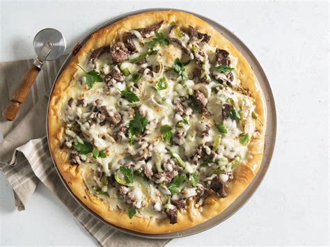 Philadelphia cheesesteak pizza. Preheat oven to 425°F. Lightly grease a baking sheet with baking spray or olive oil. In a medium skillet over medium heat, cook shaved steak until nearly done. Drain and set aside. In a small bowl, combine … 