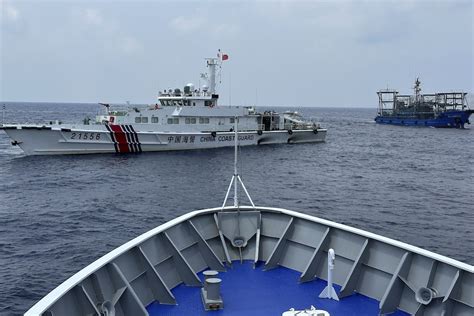 Philippines says a coast guard ship and supply boat were rammed by Chinese vessels at disputed shoal