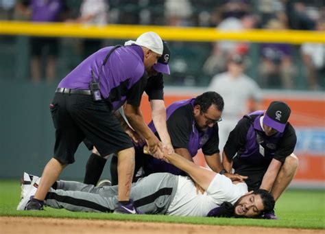 Photos: Fan rushes field during Rockies-Yankees game