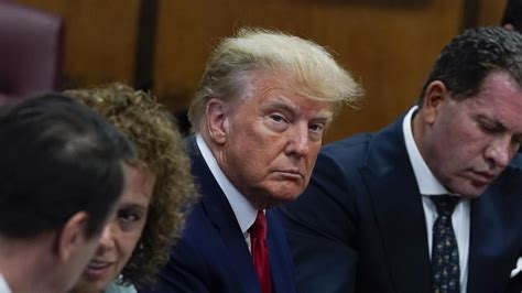 Photos show stone-faced Trump navigate historic arraignment
