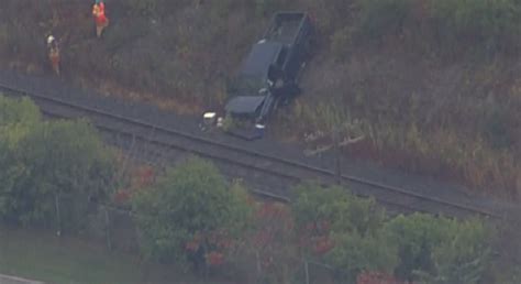 Pickup truck crashes into ditch near train tracks in Pickering