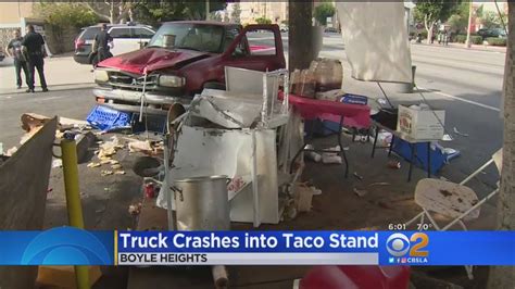 Pickup truck crashes into taco stand; driver reportedly brandishes gun