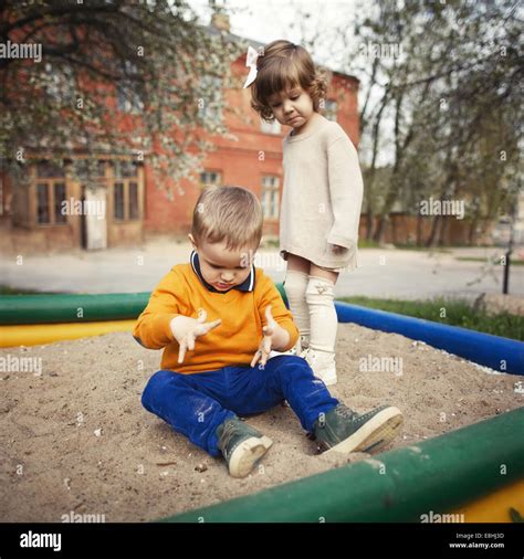 Picture boy girl sandbox.  Sandbox Stock Photos And Images Unlock a wor...