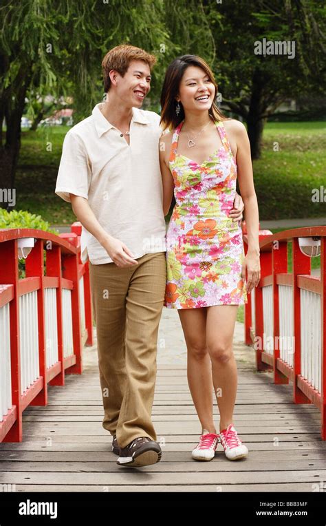 Picture young couple bridge sitting sidewalk.  Find Couple Walking Over Bridge s...