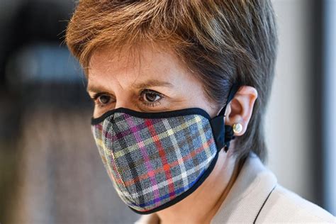 Pictures show Nicola Sturgeon donning a tartan face mask as she …