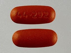 This brown elliptical / oval pill with impri