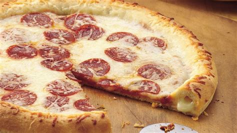Pillsbury pizza crust recipes. Heat oven to 375°F. Spray two large cookie sheets with cooking spray. 2. Separate dough, and press into 6-inch rounds; place onto cookie sheets. 3. Top each round with pizza sauce, cheese and pepperoni. 4. Bake one cookie sheet at a time on middle oven rack 12 to 16 minutes or until bottoms are deep golden brown and cheese is bubbly. 