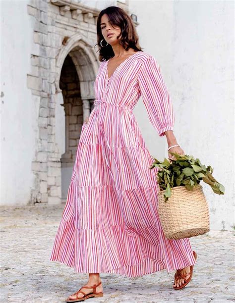 Pink city prints. Finished with rows of intricate, cross-stitch borders in the prettiest shades of pink and green, our Celine dress is a real showstopper. Crafted from neatly pin-tucked white cotton, the Celine dress is perfect for holiday dinners, special occasions and wafting around a new city. Finished with a flattering, square neckline, vintage-inspired ... 