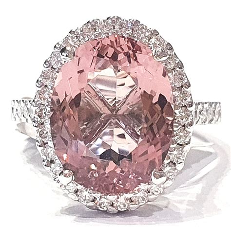 Pink gemstone ring. This dazzling 0.75ct natural pink tourmaline is set in a diamond halo rose gold design. which is breathtakingly beautiful. The unique gold cage helps to ... 