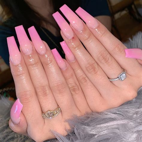 Pink long square acrylic nails. This extremely long manicure has two nail shapes instead of one: The index and pinky fingers are lengthy stilettos, while the middle and ring fingers take on a … 
