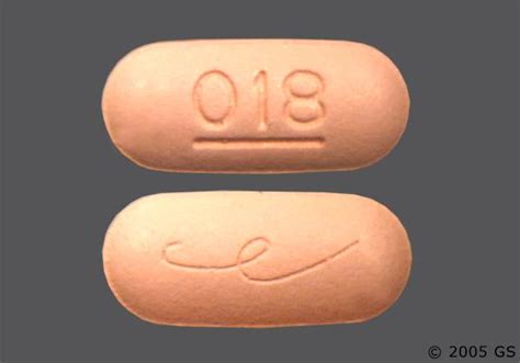 Pill Imprint E 018. This orange elliptical / oval pill with impri