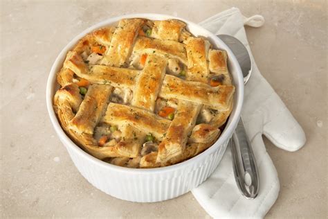 Pioneer woman chicken pot pie puff pastry. Divide the chicken mixture equally into the four bowls, over the cheese. Place a puff pastry square over the top of each bowl, pressing lightly around the rim. Brush the pastry with the egg and water mixture. Place the four bowls on a baking sheet. Bake until pastry is puffed and golden brown, about 25 minutes. 