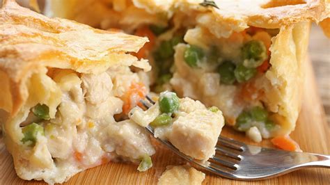 Add cream and broth and simmer until thickened. Stir in chicken, peas, and parsley and remove from heat. Roll out pie crust to 12″ and transfer to a pie pan. Add Filling into crust and cover with the second crust. Crimp edges, cut slits, brush with egg wash and bake. Make-Ahead Tip: Chicken pot pie reheats beautifully.. 