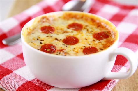 Pizza in a mug. Steps: In a large mug, mix flour, baking powder, bicarbonate of soda and salt. Then add milk and olive oil and stir well. Spoon the top with tomato sauce and sprinkle the cheese and oregano. Microwave for 1 minute then add the pepperoni slices. Microwave again for 10-20 seconds then let cool before consuming. 