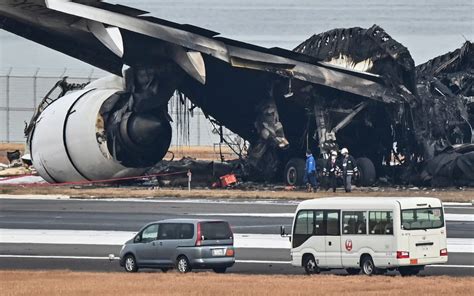 Plane burns on runway at Tokyo airport after collision