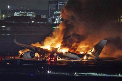 Plane burns on runway at Tokyo airport after collision, five dead