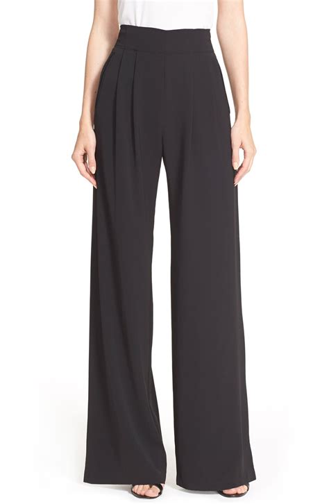 Pleated trousers pants. Crafted from a fine, soft crepe textured fabric, these wide flared trousers flow with elegance and ease. Easy to care for, they will hold you down well in ... 