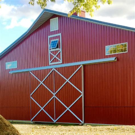 Pole barn sliding door. Get the most for your money with these Pole Barns. Standard features also include: 24’, 30’, 40’ widths x any length. Treated post & skirt board. 2x4 wall girts. T1-11 with cedar trim or vinyl siding & trim. Truss w/ 1' eave & gable overhangs & soffit. 25 yr. Fiberglas® shingles with 15# felt over 1/2" OSB sheathing. 
