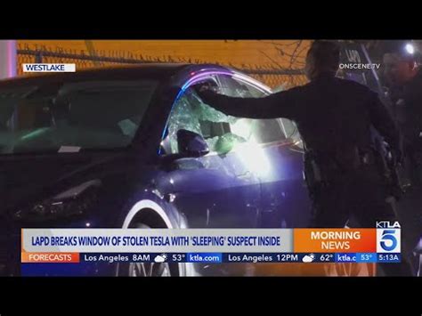 Police break window of stolen Tesla to get to suspect